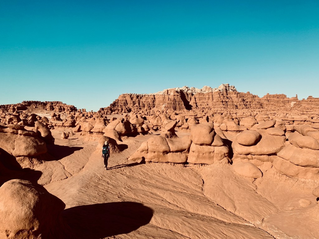 Woman walks through Valley of the Goblins at Goblin Valley State Park