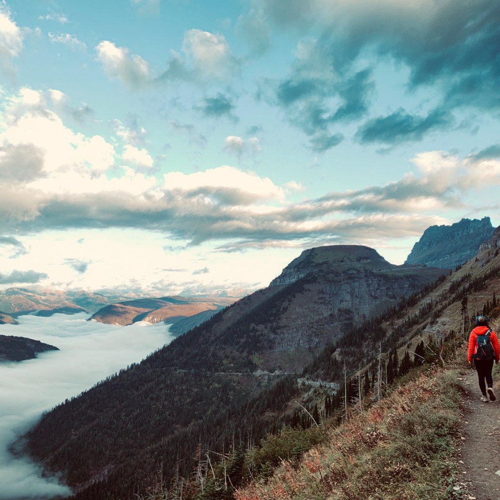Woman hiking the highline trail to grinnell glacier in Glacier National Park in Montana