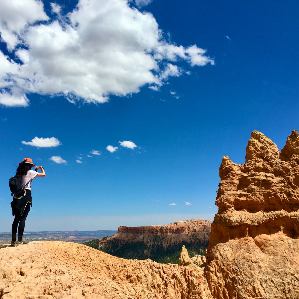 Woman takes picture of the Bryce Canyon National Park landscape in Utah